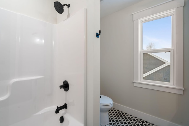 bathroom featuring toilet and shower / bathtub combination