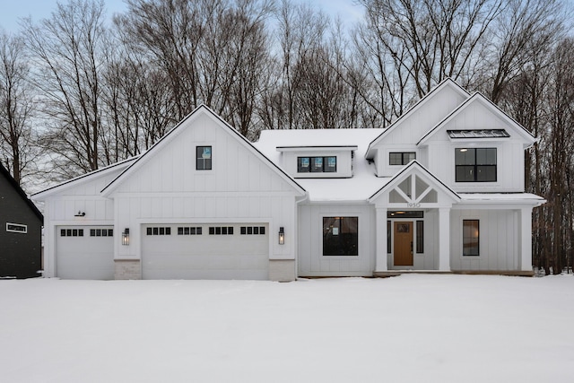 modern inspired farmhouse with a garage