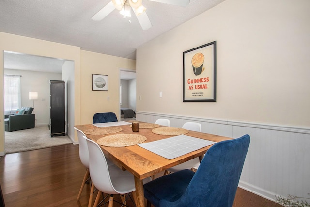 dining space featuring a textured ceiling, ceiling fan, and dark hardwood / wood-style floors