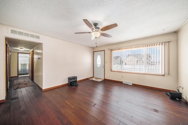 foyer with dark wood-type flooring, ceiling fan, and a healthy amount of sunlight