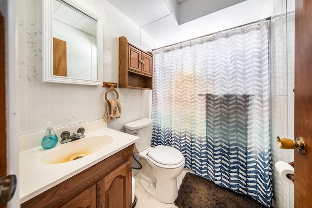 bathroom featuring curtained shower, tile walls, toilet, tile patterned floors, and vanity