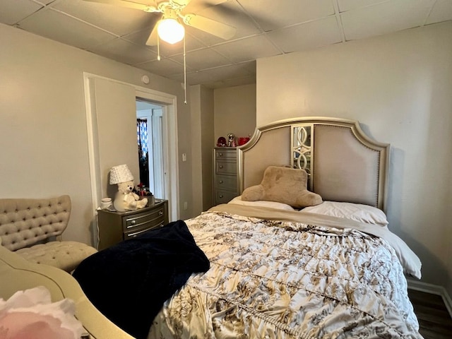 bedroom with ceiling fan and a paneled ceiling