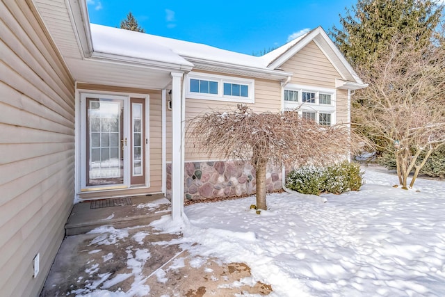 view of snow covered property entrance