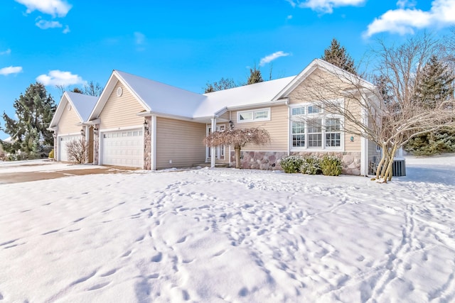 view of front of home featuring a garage and central AC unit