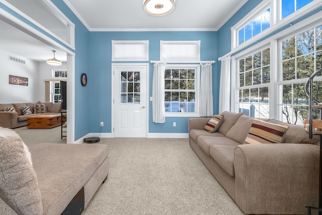 carpeted living room featuring ornamental molding and plenty of natural light