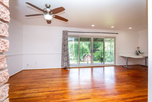 spare room with ceiling fan and wood-type flooring