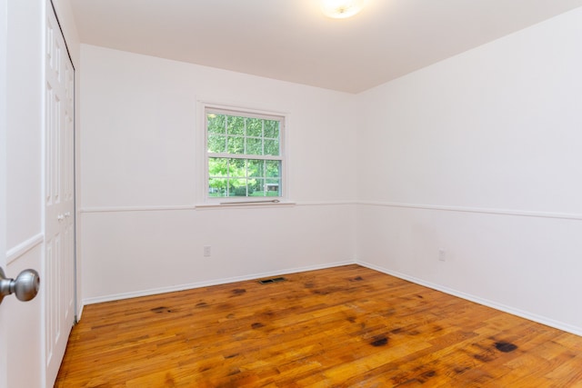 21918 Knudsen Dr, Grosse Ile, MI 48138 - empty room featuring wood finished floors and baseboards