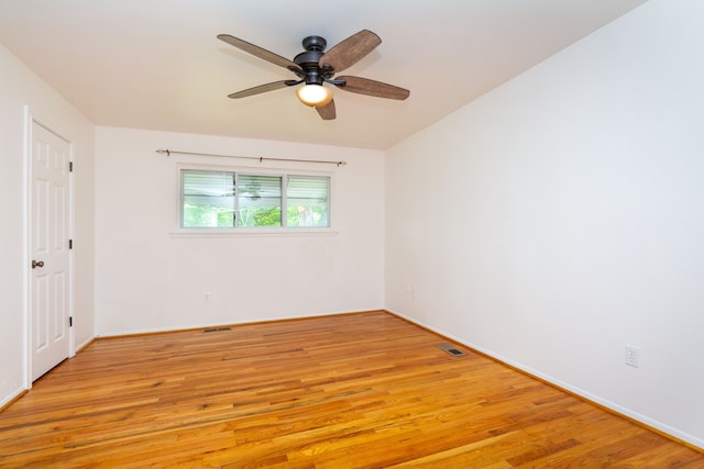 21918 Knudsen Dr, Grosse Ile, MI 48138 - unfurnished room featuring light wood-type flooring, a ceiling fan, and baseboards