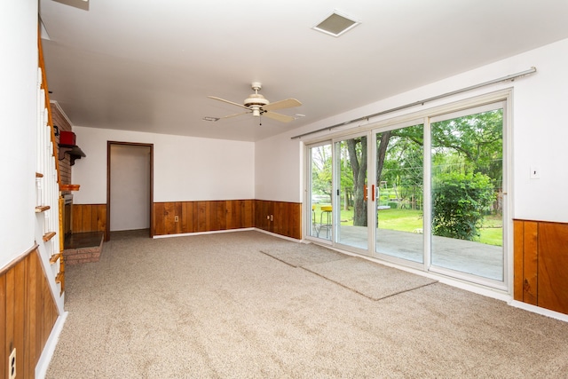 21918 Knudsen Dr, Grosse Ile, MI 48138 - carpeted spare room with wood walls, a wainscoted wall, healthy amount of natural light, and ceiling fan