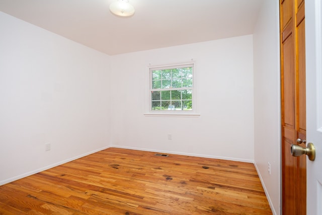 unfurnished room with wood-type flooring