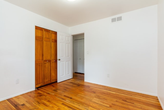 unfurnished bedroom with light wood-type flooring