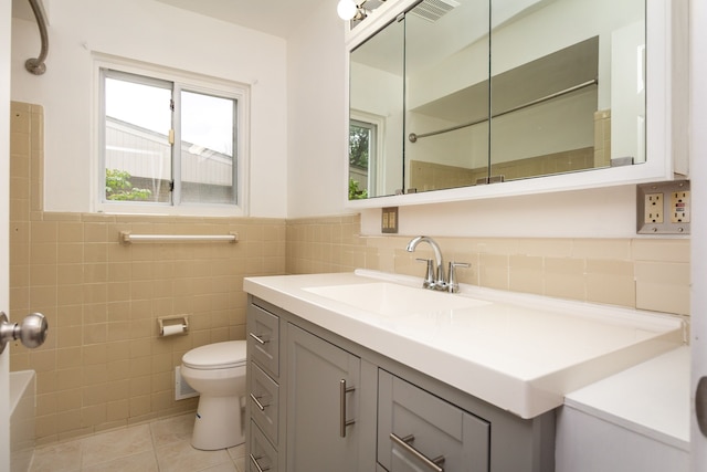 21918 Knudsen Dr, Grosse Ile, MI 48138 - bathroom with tile patterned flooring, tile walls, toilet, a wainscoted wall, and vanity
