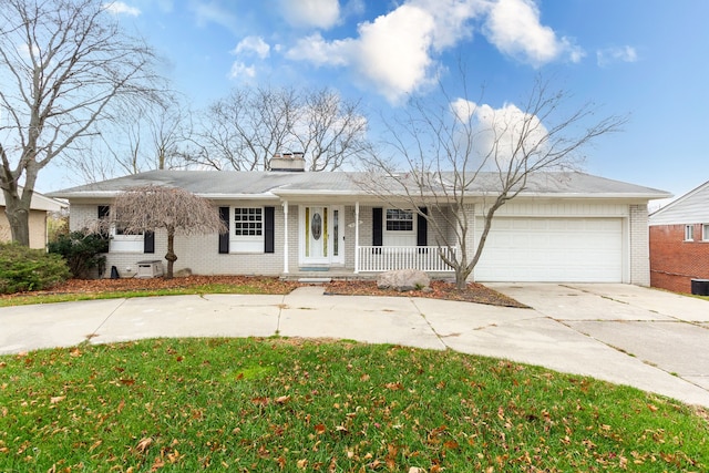 ranch-style home with covered porch and a garage