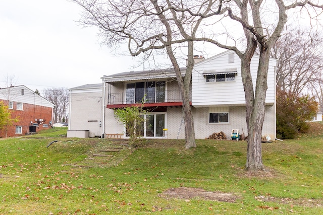 rear view of property with a yard