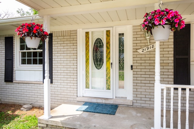 21918 Knudsen Dr, Grosse Ile, MI 48138 - view of exterior entry with brick siding and covered porch