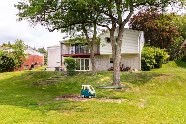 21918 Knudsen Dr, Grosse Ile, MI 48138 - back of property featuring brick siding and a yard