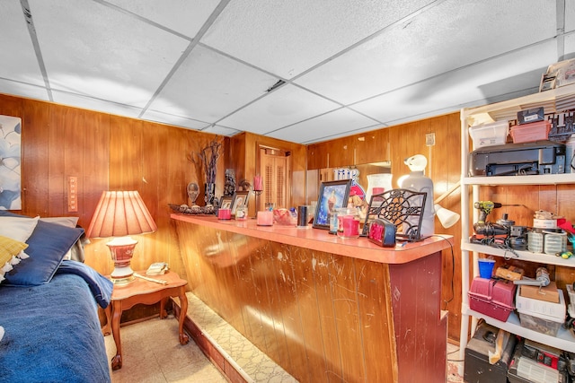 bar with a paneled ceiling and wooden walls