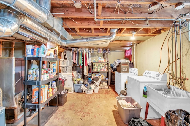 basement featuring separate washer and dryer and sink