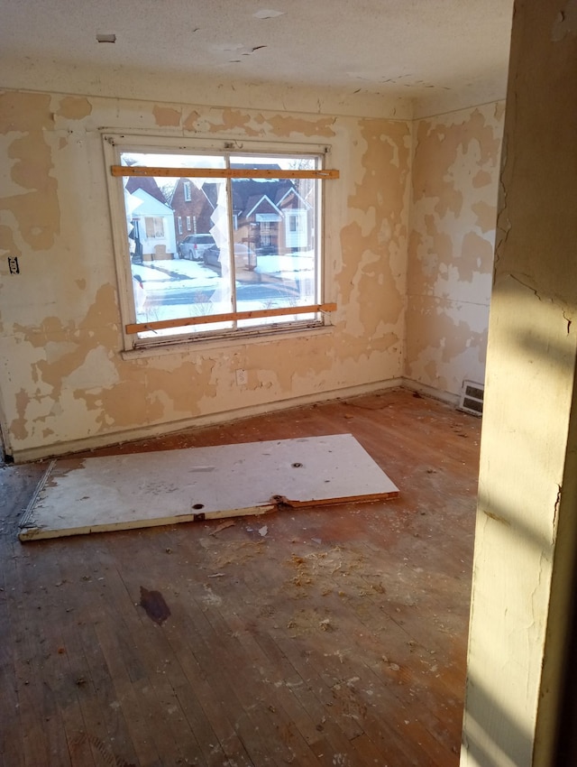 empty room featuring hardwood / wood-style floors