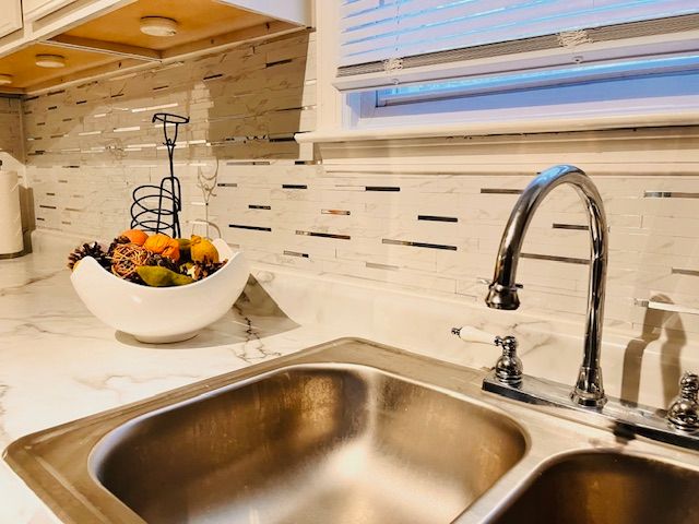 details featuring light stone counters and sink