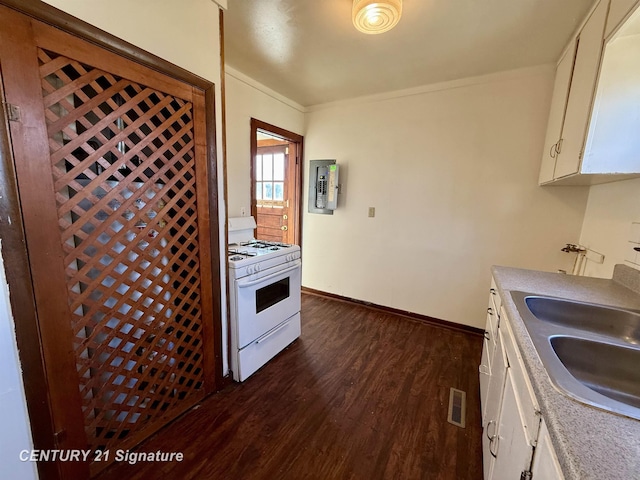 kitchen featuring white cabinets, dark wood-type flooring, white range with gas cooktop, and sink