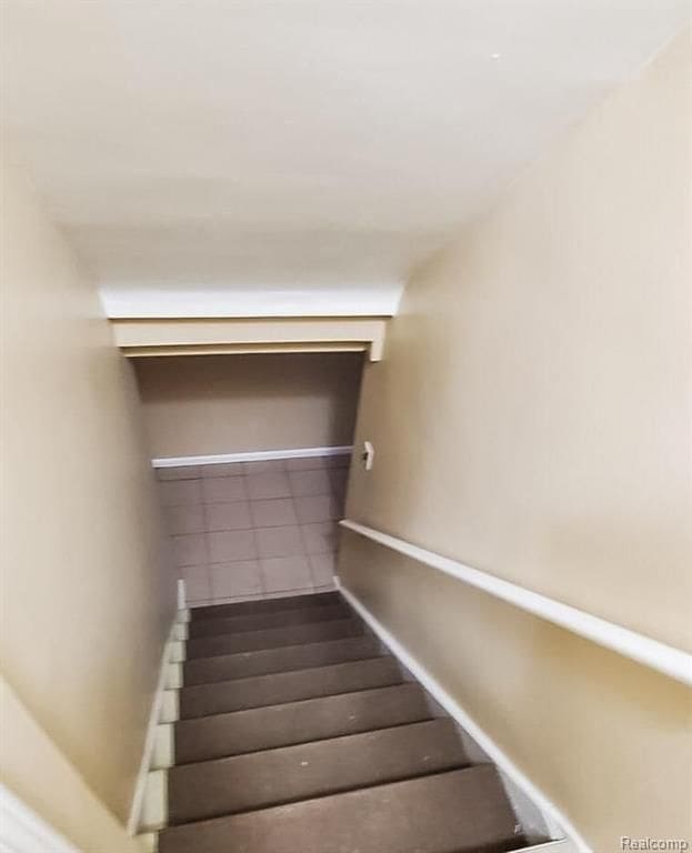 staircase with tile patterned flooring