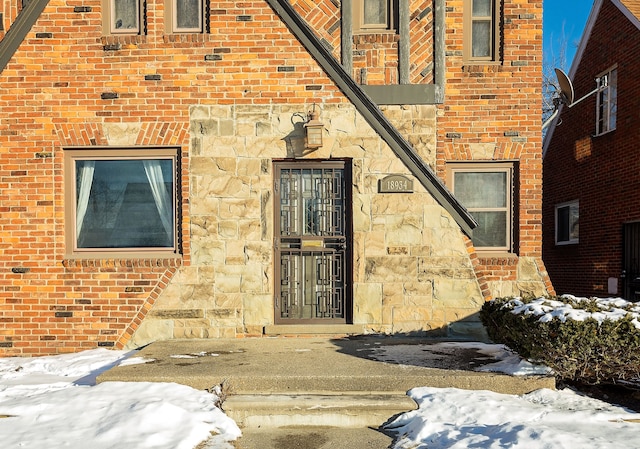 view of snow covered property entrance