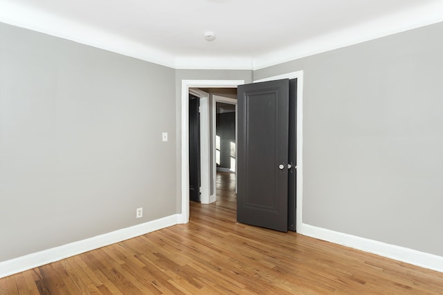 unfurnished room featuring hardwood / wood-style flooring