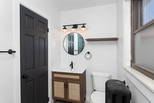 bathroom with toilet and vanity