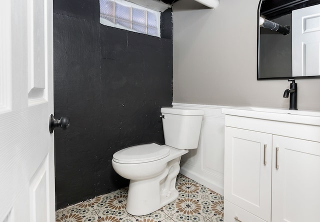 bathroom featuring toilet, vanity, and tile patterned flooring