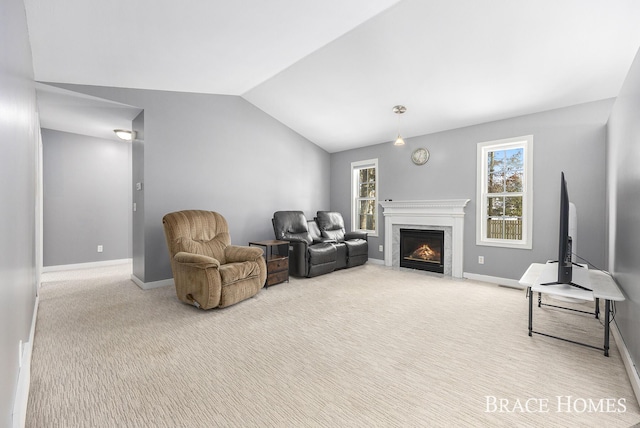 living room with lofted ceiling and carpet floors