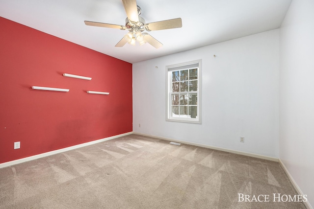 carpeted empty room with ceiling fan