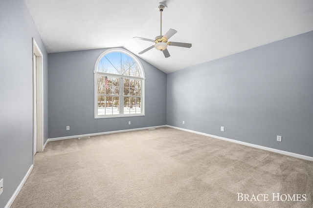 unfurnished room featuring lofted ceiling, light colored carpet, and ceiling fan