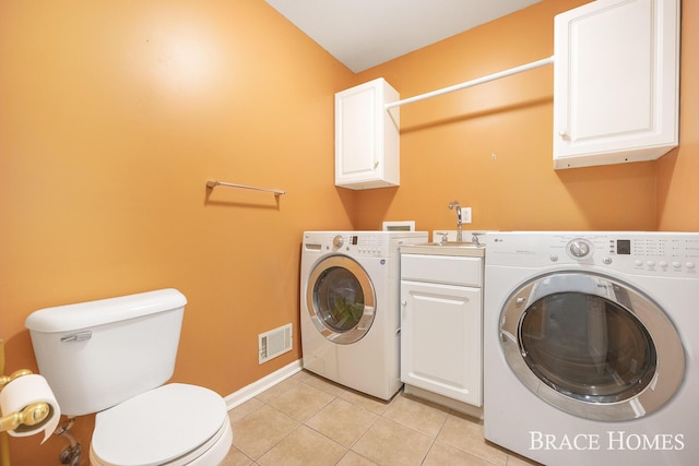 laundry room featuring washer and dryer, light tile patterned floors, and sink