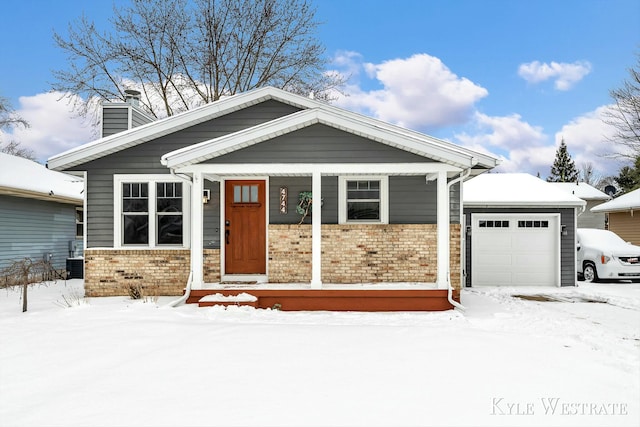 craftsman-style home with central AC unit and a garage