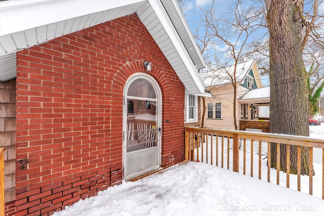 view of snow covered property entrance