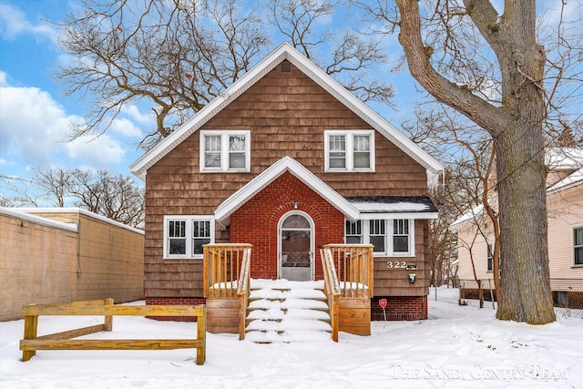 view of snow covered back of property