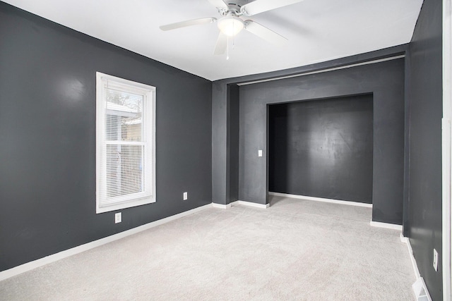 carpeted empty room with ceiling fan