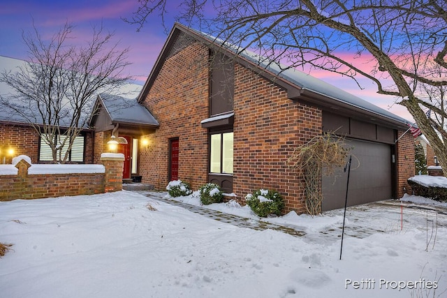 view of snow covered exterior featuring a garage