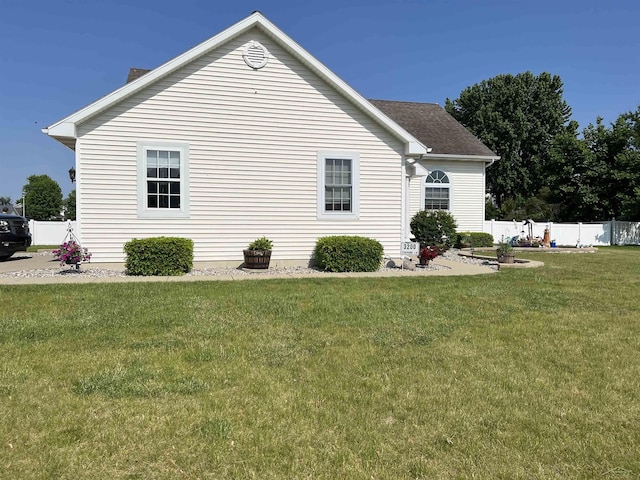 view of side of home featuring a lawn