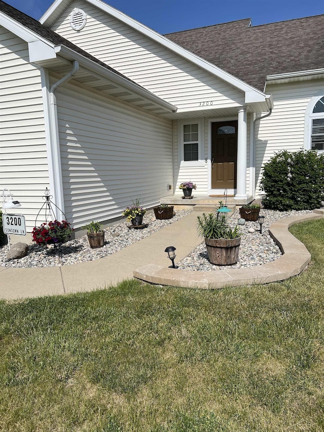 doorway to property with a yard