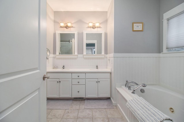 5 Georgia Ct, Pentwater, MI 49449 - bathroom featuring tile patterned flooring, a wainscoted wall, a sink, a bath, and double vanity