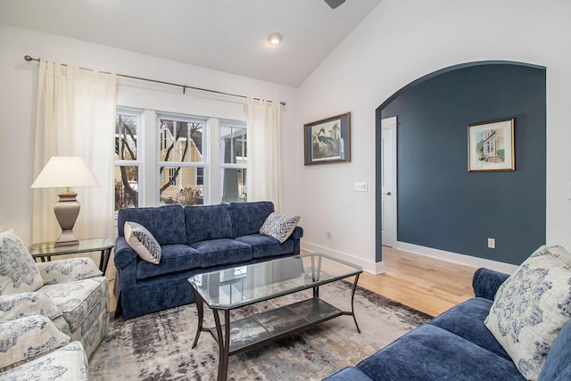 5 Georgia Ct, Pentwater, MI 49449 - living area featuring arched walkways, vaulted ceiling, baseboards, and wood finished floors