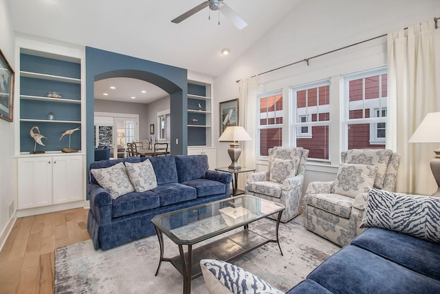 5 Georgia Ct, Pentwater, MI 49449 - living area with built in shelves, arched walkways, lofted ceiling, a ceiling fan, and wood finished floors
