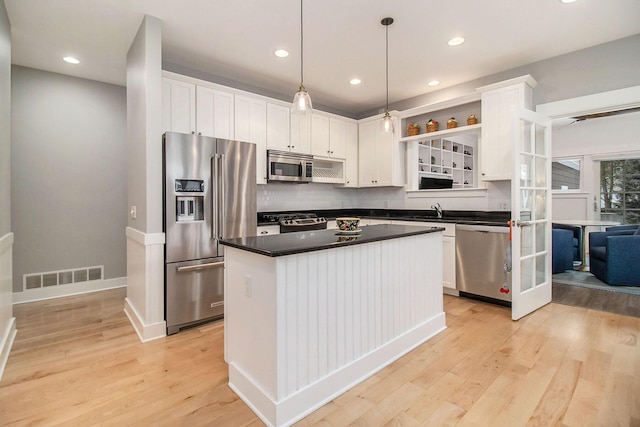 5 Georgia Ct, Pentwater, MI 49449 - kitchen featuring visible vents, white cabinets, dark countertops, stainless steel appliances, and open shelves