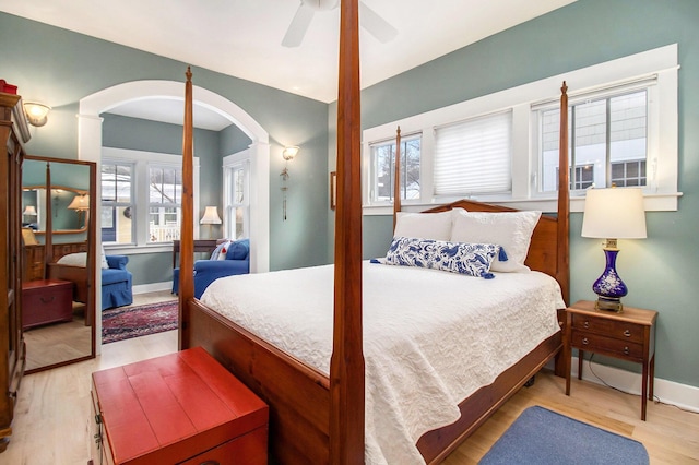 5 Georgia Ct, Pentwater, MI 49449 - bedroom featuring light wood-style flooring, multiple windows, baseboards, and a ceiling fan