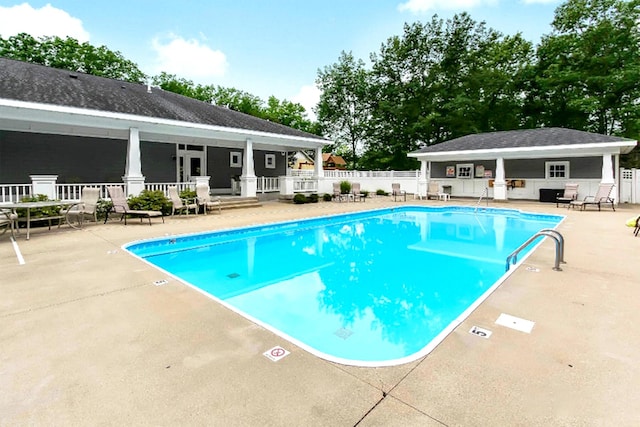 5 Georgia Ct, Pentwater, MI 49449 - community pool featuring a patio area, fence, and an outdoor structure