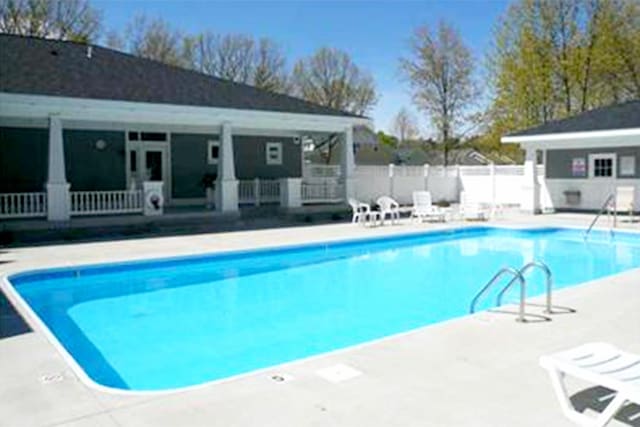 5 Georgia Ct, Pentwater, MI 49449 - pool featuring a storage structure, fence, an outbuilding, and a patio