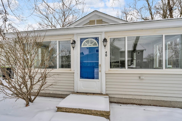 view of snow covered property entrance