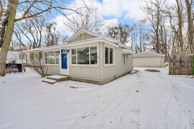 view of front of home with a garage and an outdoor structure